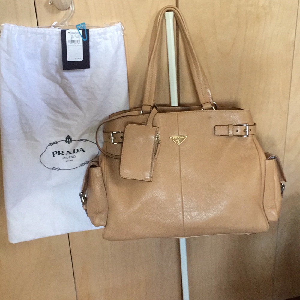 Prada Authenticate  leather bag w/ side pockets.